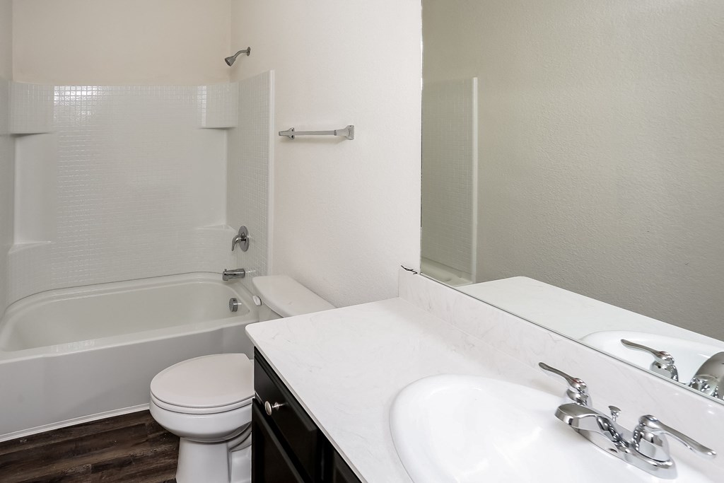 an empty bathroom with a sink toilet and bath tub