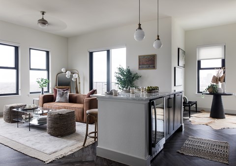 A modern living room with a brown chair and a grey cabinet.
