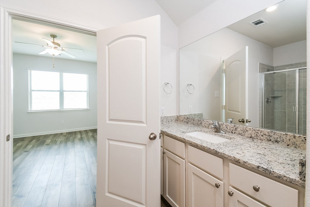 3 Bedroom Single Family Homes for rent in Crowley TX- Lasater Ranch - An interior shot of the bathroom, featuring a sink, mirror, and a shower
