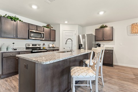 a kitchen with a granite counter top and stainless steel appliances