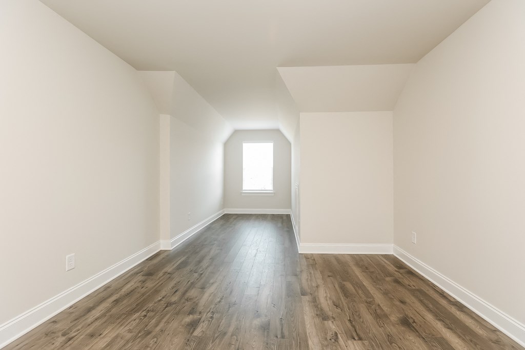 an empty room with white walls and a window