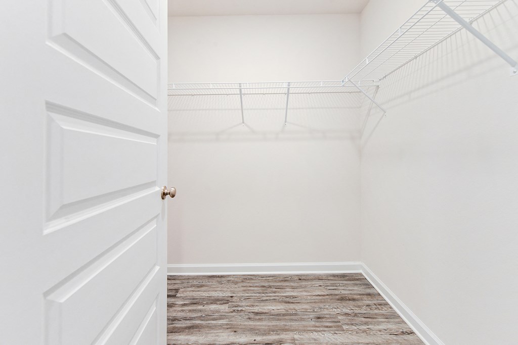an empty closet in a home with a white door