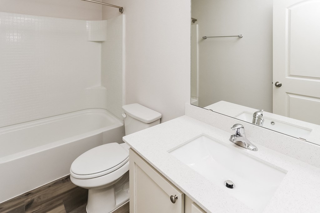 a bathroom with a sink toilet and a mirror