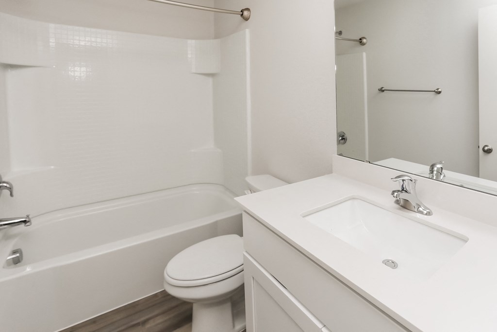 a bathroom with a sink toilet and a tub