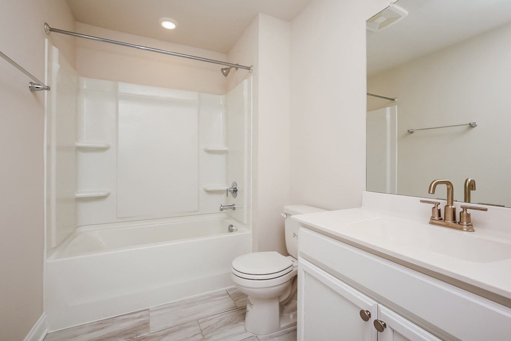 a bathroom with a sink toilet and a tub