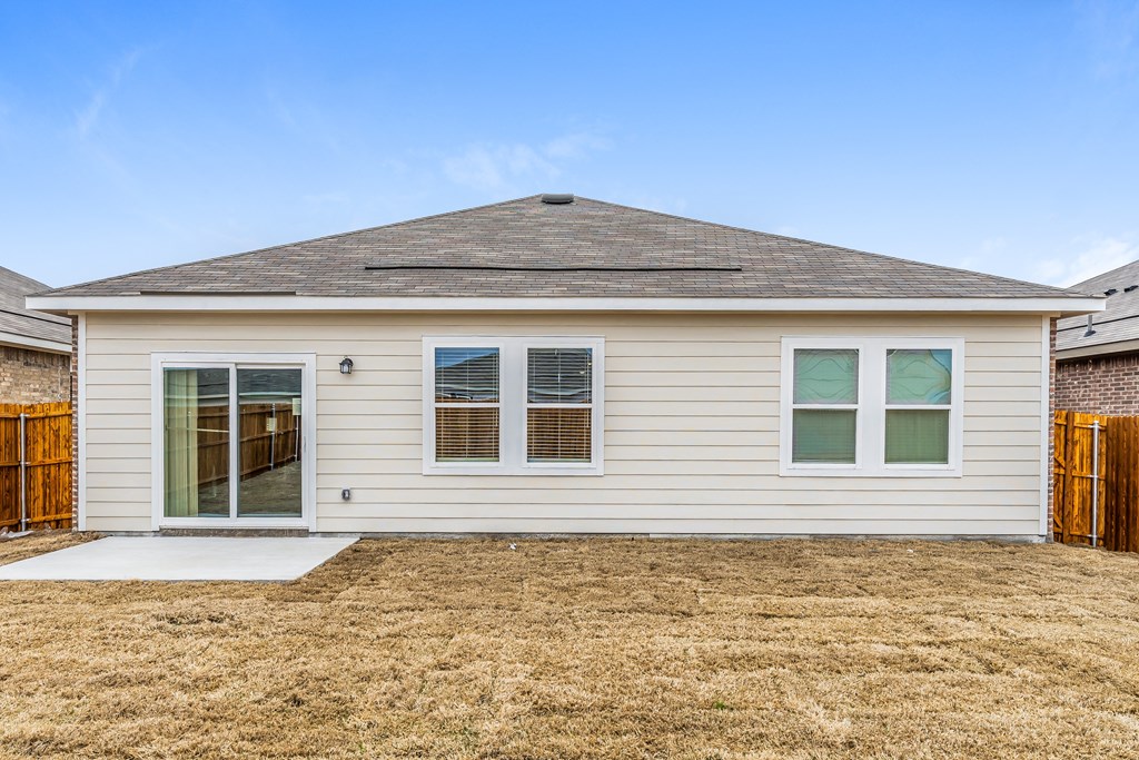 the front of a white house with a yard