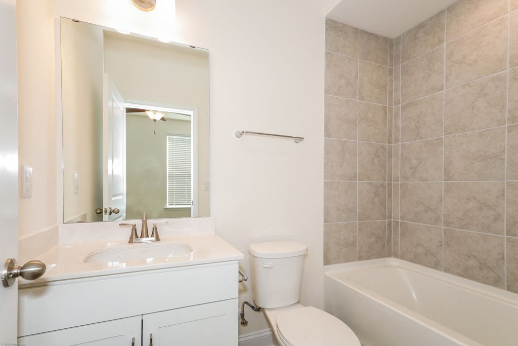 Charlotte NC Luxury Apartments for Rent - Loso Walk - Bathroom With Vinyl Plank Flooring, Vanity Sink, Toilet, And Shower With Tub Combo.