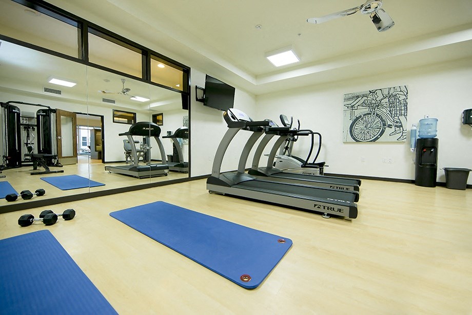 Studio Apartments in Sherwood OR - Cannery Row - Gym with Wood-Style Floor, Mats, Weights, Treadmill, Eliptical, Mirror Wall, Lighting, and Water Dispenser