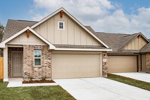 a house with a gray roof and a brown garage door