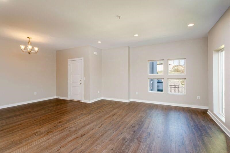 an empty living room with white walls and wood floors