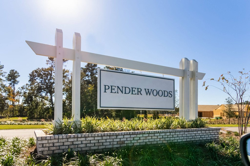 a sign that reads pender woods in front of a building
