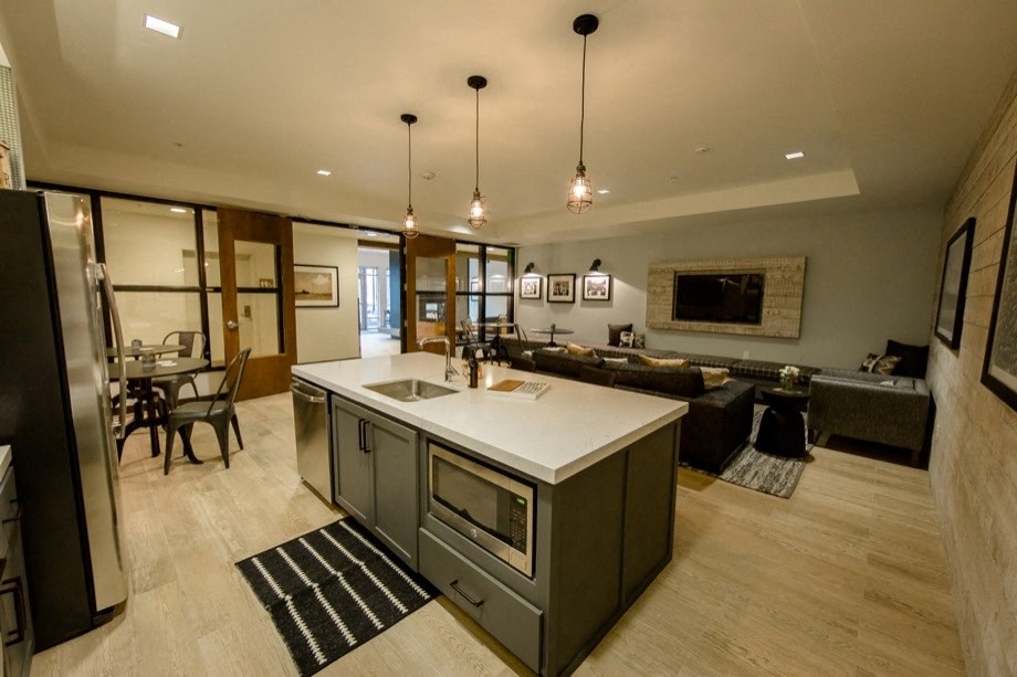 the kitchen and living room of a modern house