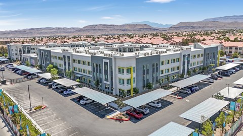 A large building with a parking lot in front of it.