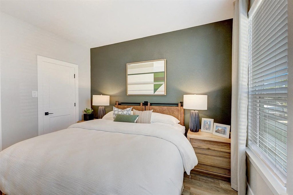 a bedroom with a bed and a window