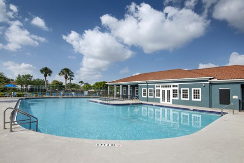 A large swimming pool with a building next to it.