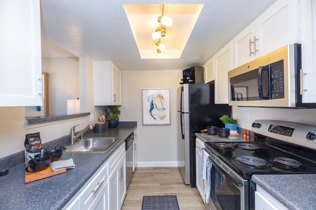 a spacious kitchen with stainless steel appliances and granite counter tops