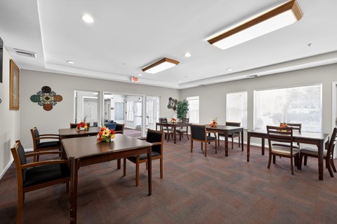 A dining room with a long table and chairs.