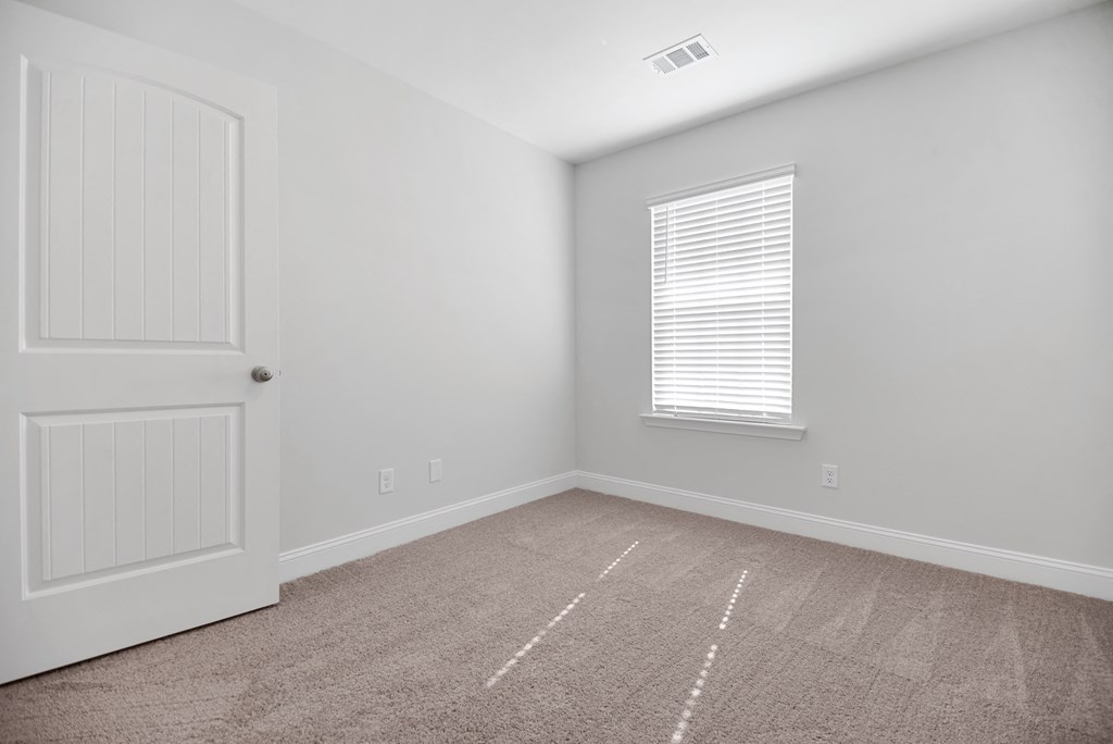 Cottonvale Towns in Savannah, GA photo of guest bedroom with plus carpeting and a window