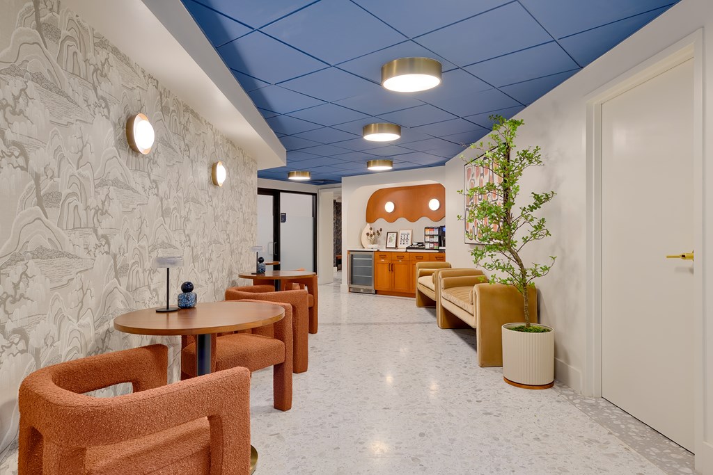 A room with a blue ceiling and a white wall with a pattern on it.