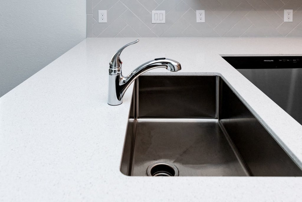 a kitchen sink with a faucet