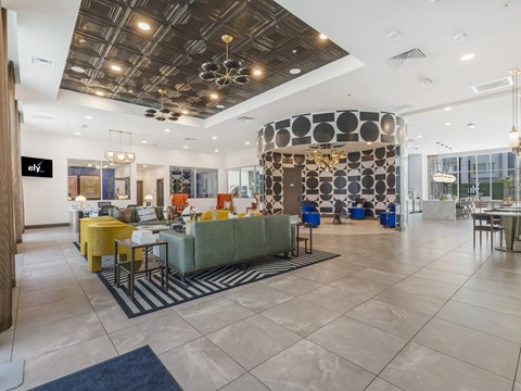 A modern office lobby with a reception desk and seating areas.