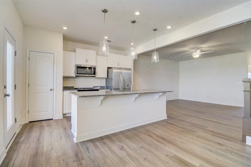 a kitchen and living room with a large island