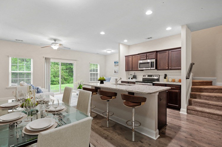 Omnia at Richmond Hill Townhomes in Georgia photo of a kitchen and dining area with a table and chairs and a counter top