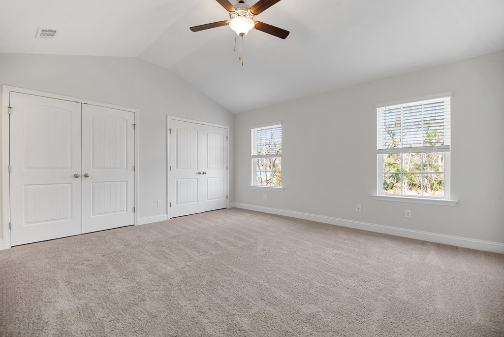 Cottonvale Towns in Savannah, GA photo of bedroom with plush carpeting and ceiling fan