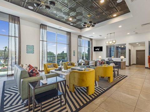 A modern living room with a glass ceiling and a striped rug.