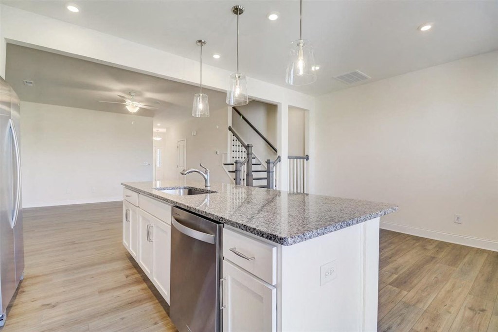 a kitchen with an island and stainless steel appliances