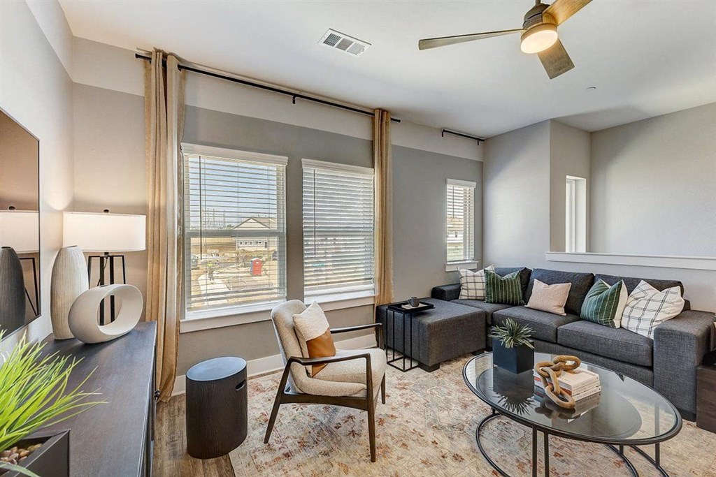 a living room with gray walls and a large window