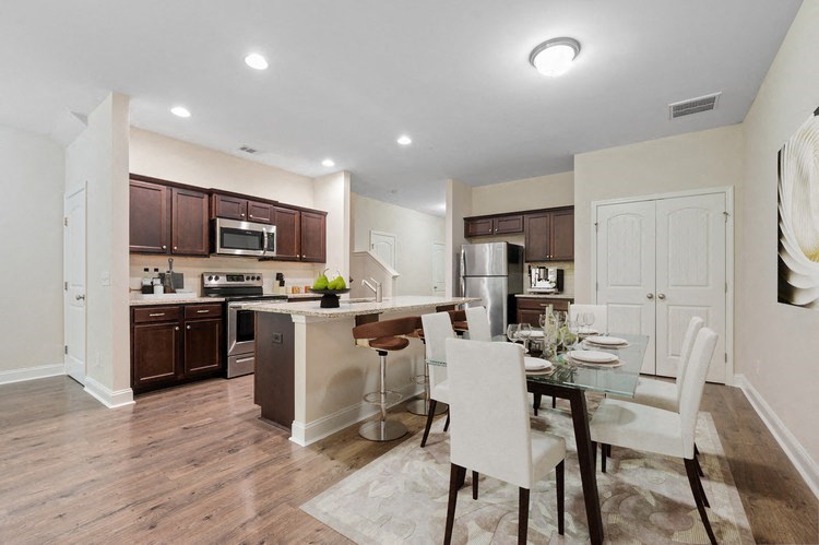 Omnia at Richmond Hill Townhomes in Georgia photo of a kitchen and dining room with a table and chairs