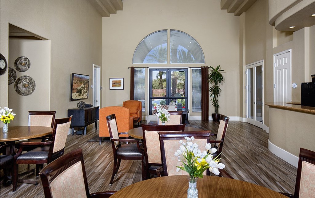 a dining room with tables and chairs and a large window