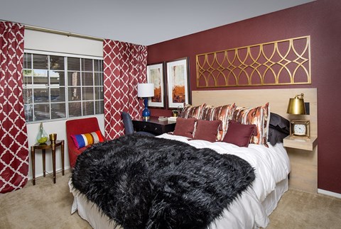 a bedroom with red walls and a bed