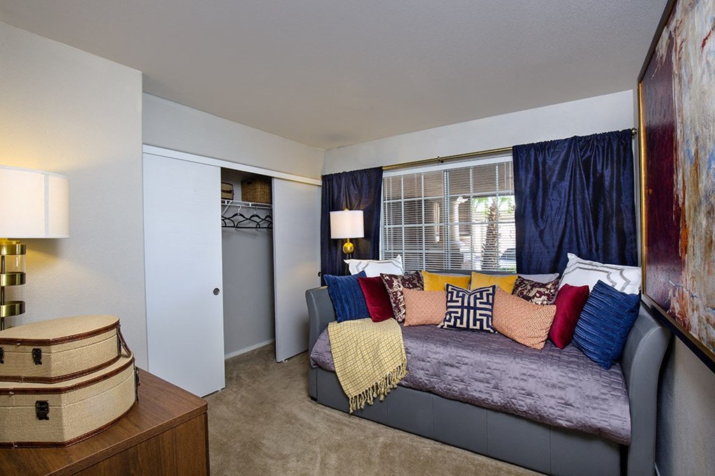 a bedroom with a bed and a dresser and a window