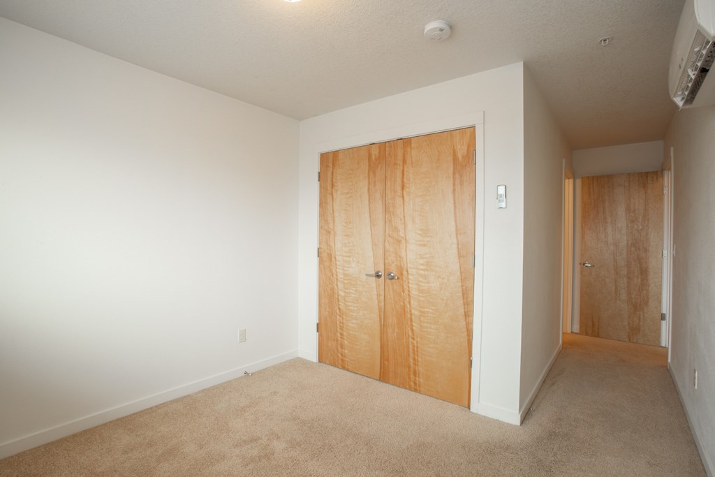 an empty room with a wooden door in the middle of it