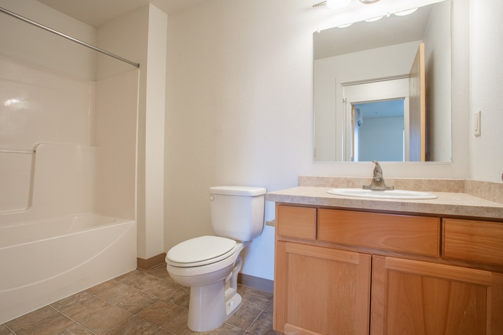 a bathroom with a toilet and a sink and a shower