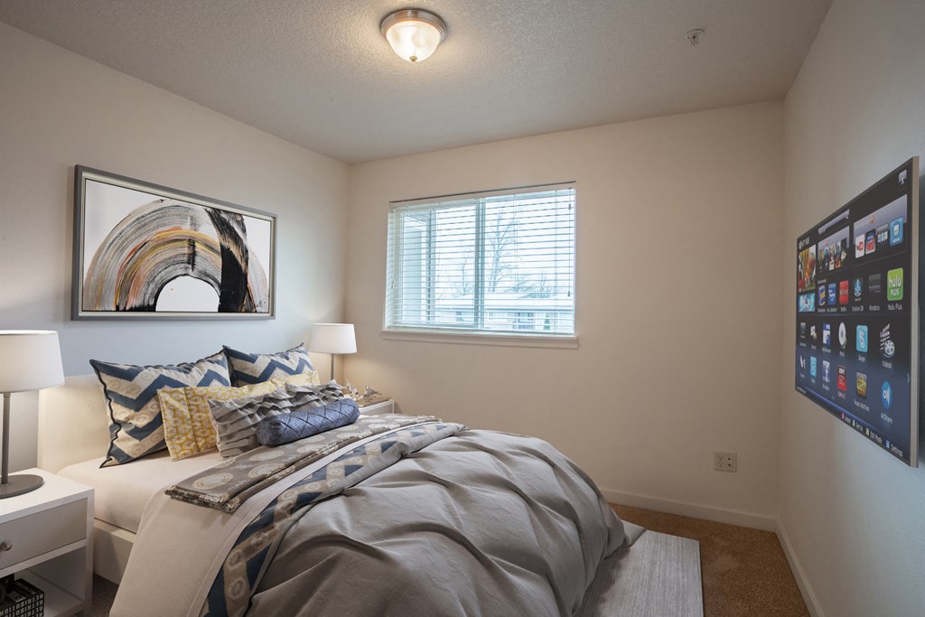 an overview of a bedroom with a bed and a window