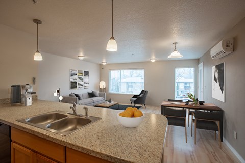 view of living room from kitchen with granite counter top looking into living room with couch