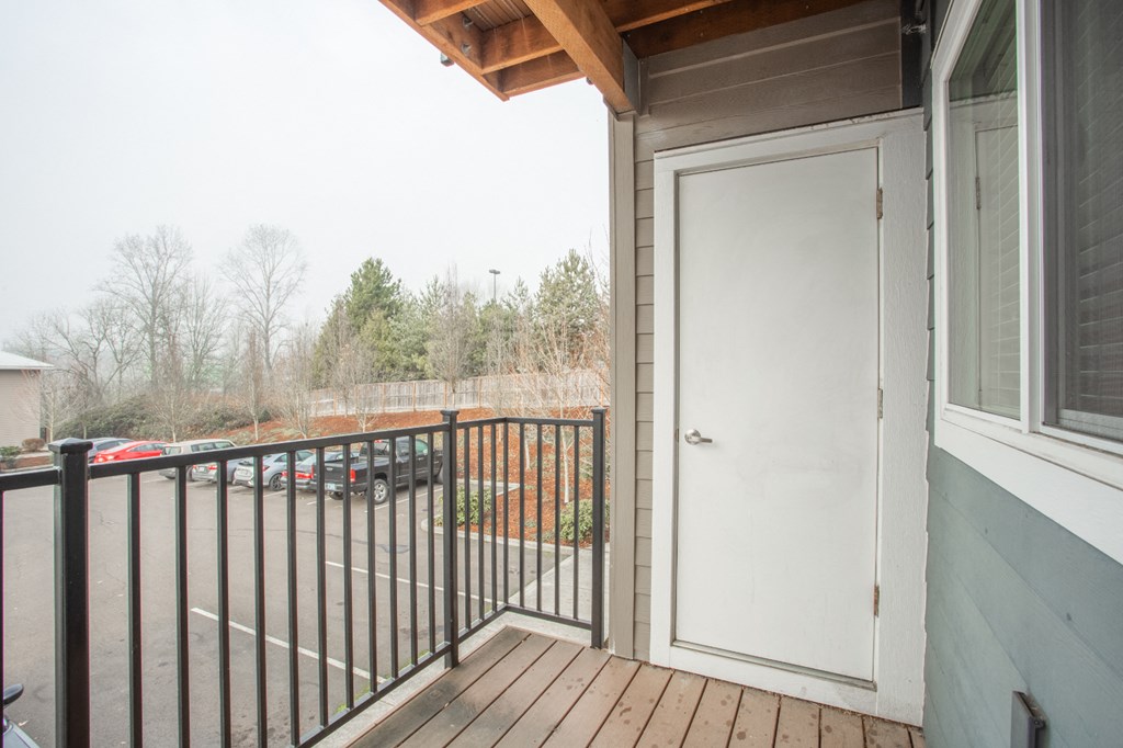 the view from the deck of a home with a white door