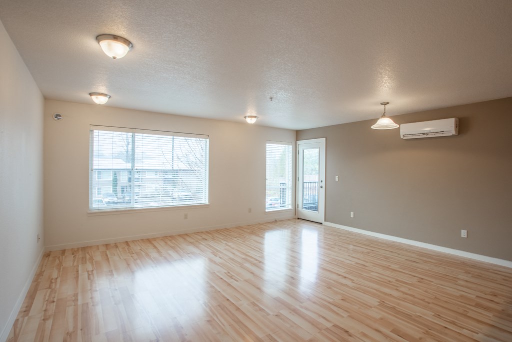 the living room of an empty house with a wood floor