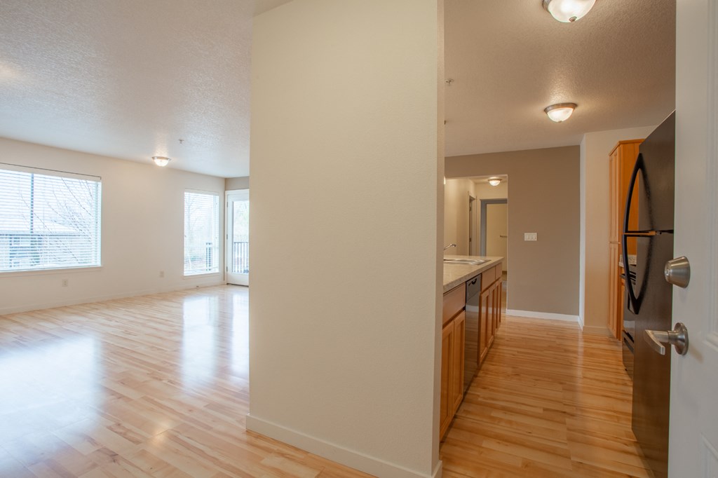 the view of a living room and a kitchen with wood flooring