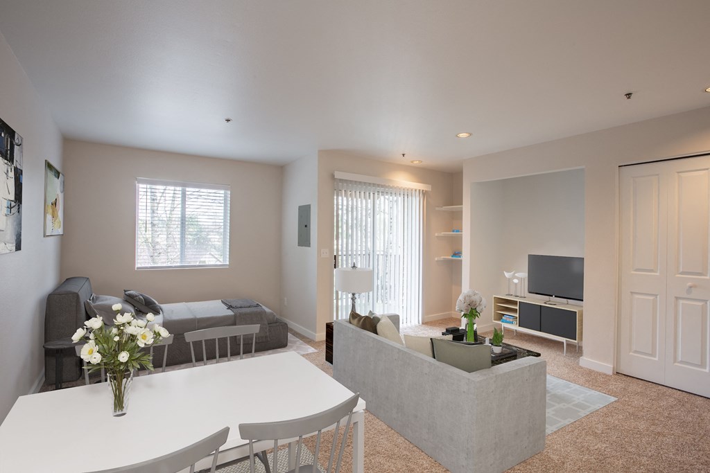 carpeted studio with balcony