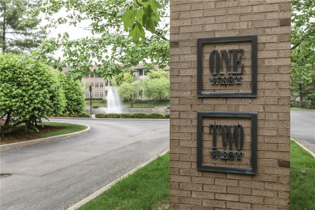 a brick building with a fountain in the background