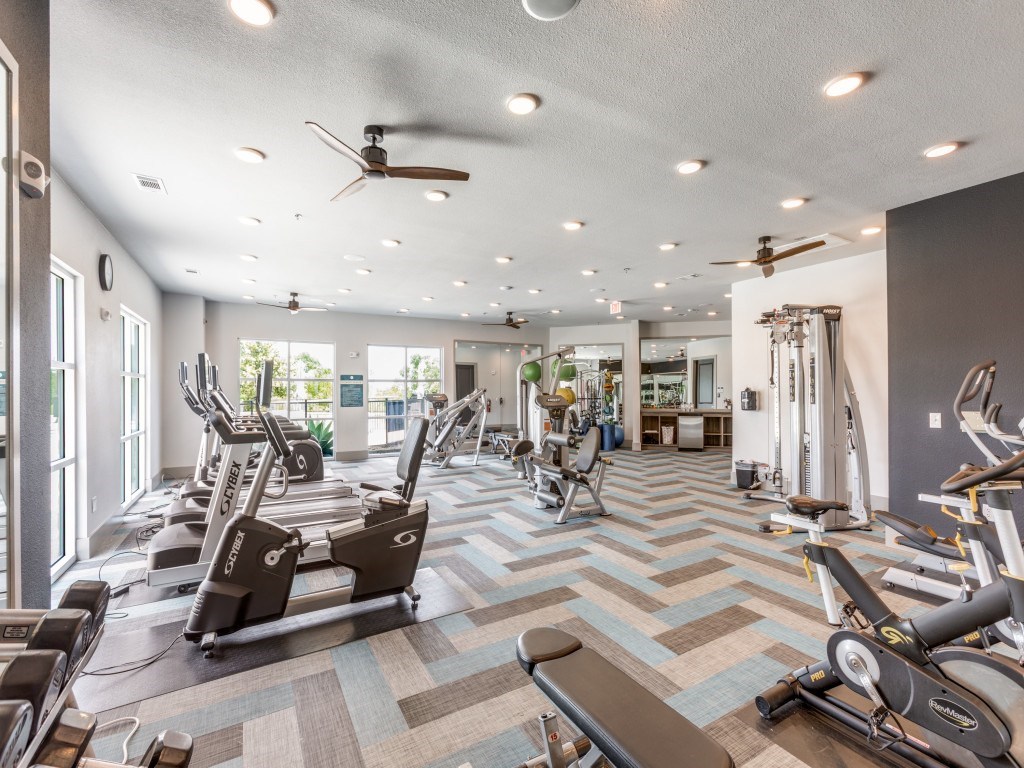 A spacious gym with a variety of exercise equipment.