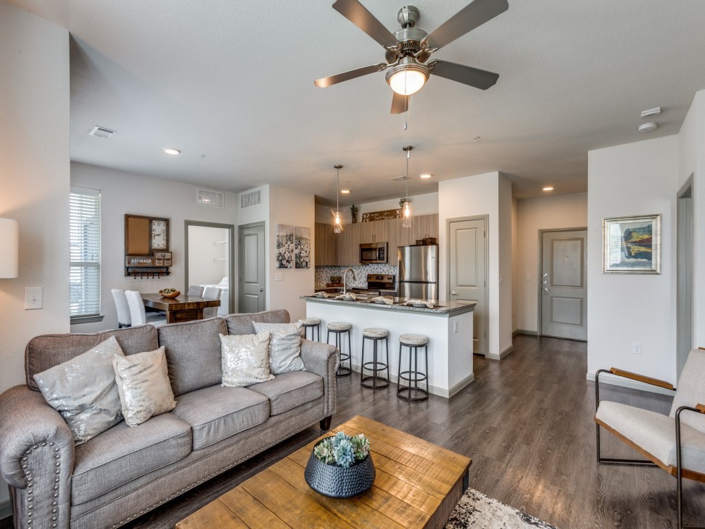 A modern living room with a grey couch and a wooden coffee table.