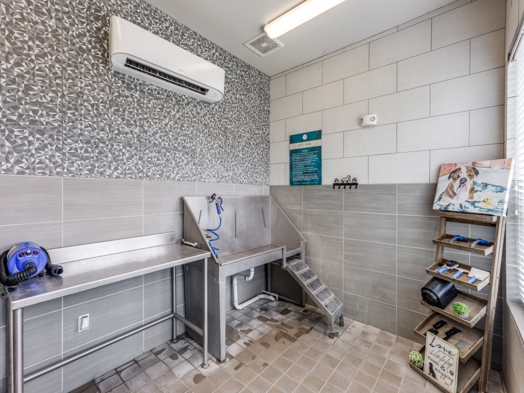 A bathroom with a shower and a toilet.