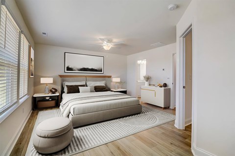 Sherrills Ford, NC, Townhomes Near Charlotte Douglas International Airport - Montera at Sherrills Ford - A Bedroom with Wide Windows, Ceiling Fan, and Light Wood Flooring.