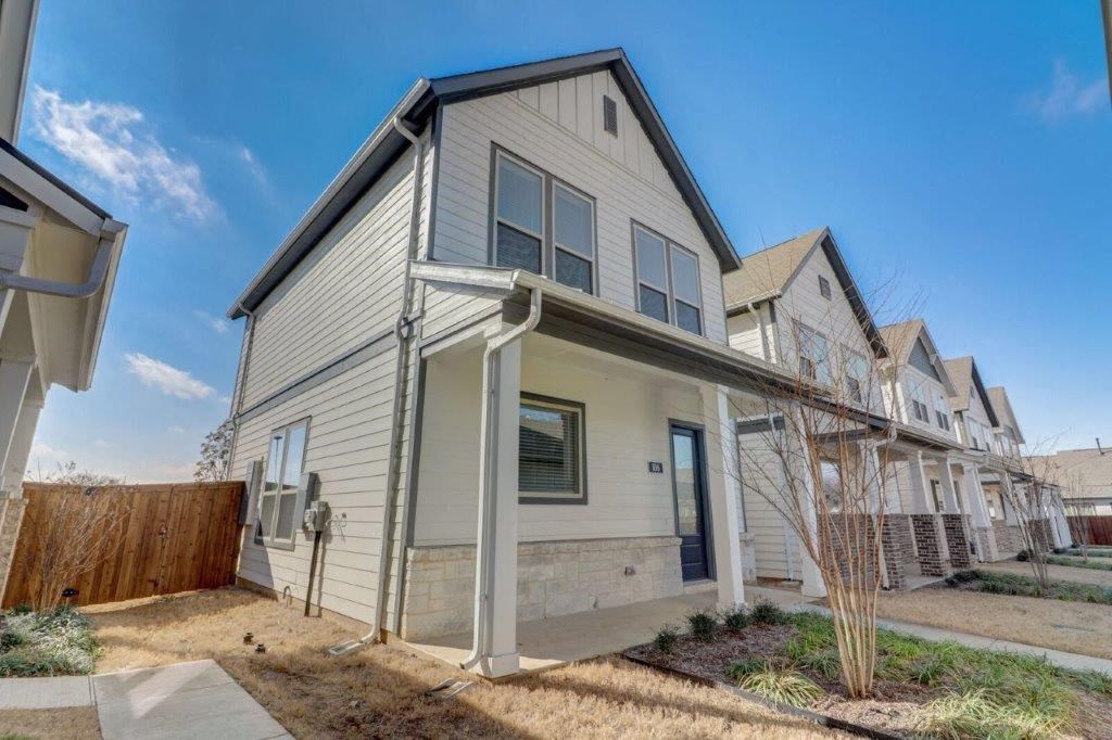 Single Family Homes for Rent in Arlington TX - Mission on Ascension - Home Exterior with White Walls, Grey Roof, Front Porch Area, Windows, Wooden Fence, and Landcaping