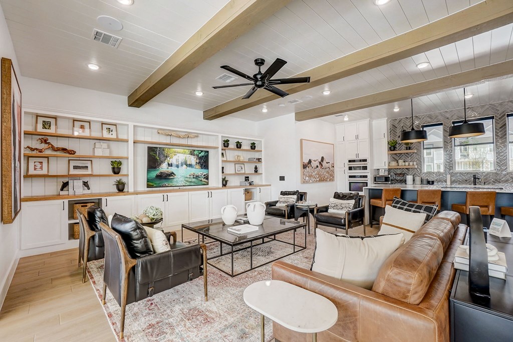a living room with furniture and a ceiling fan